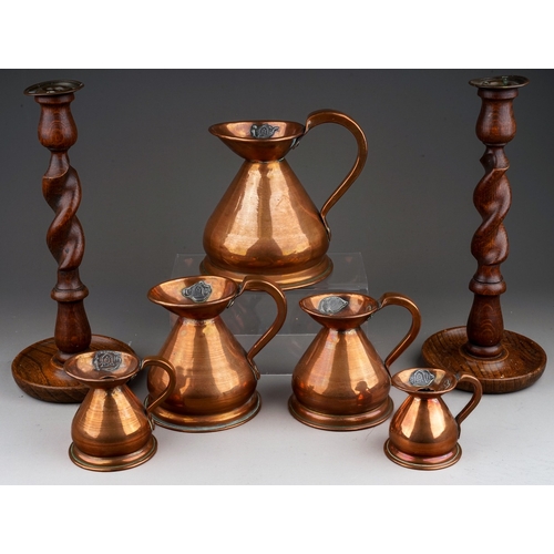 675 - A set of five 20th century copper haystack measures, tallest 16.5cm, smallest 7.5cm, together with a... 