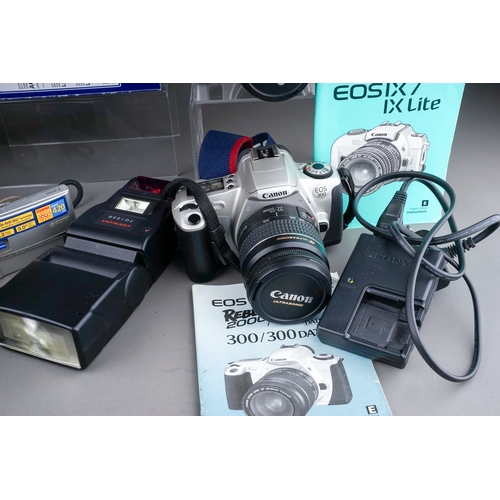 676 - A collection of digital cameras to include a Canon EOS IX7, a Canon EOS 300, Sony cyber-shot, a Sigm... 