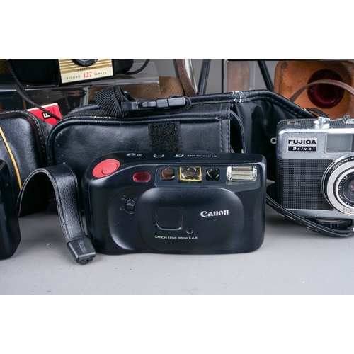 688 - A collection of film cameras to include a Canon Sureshot EX, Olympus superzoom 110, a Canon sureshot... 