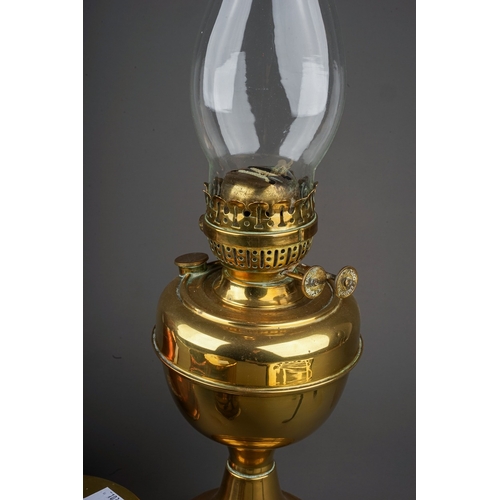 690 - A collection of brass and copperware to include: Duplex oil lamp base; a large serving jug, warming ... 