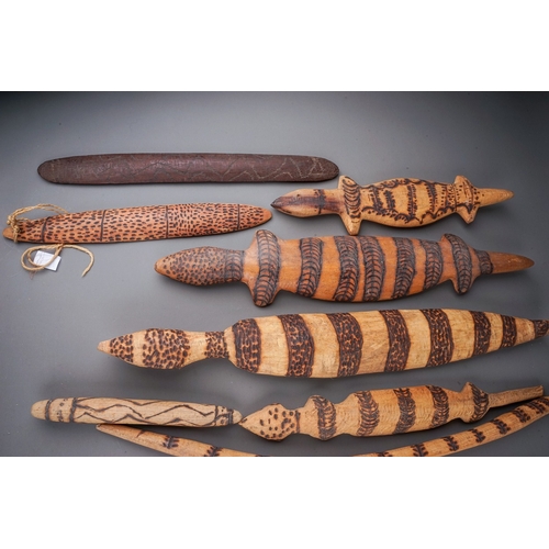 696 - A large collection of Aboriginal carved works to include: six lizards and seven snakes, each with po... 