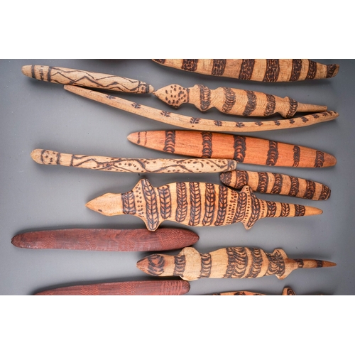 696 - A large collection of Aboriginal carved works to include: six lizards and seven snakes, each with po... 