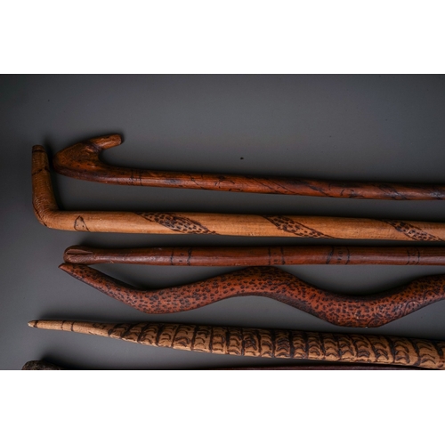 696 - A large collection of Aboriginal carved works to include: six lizards and seven snakes, each with po... 