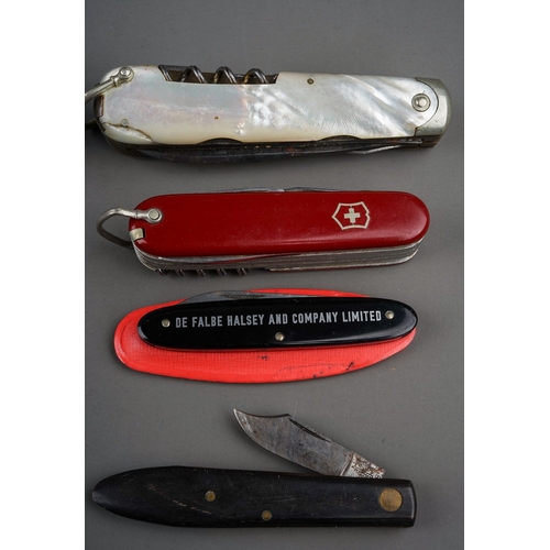 702 - A tin containing a small collection of pocket knives and cut throat razors, including a hallmarked s... 