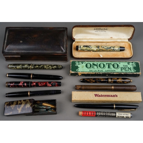 703 - A tin containing a collection of fountain pens, including cased Altura with 14k nib, a brown pen wit... 