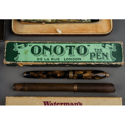 703 - A tin containing a collection of fountain pens, including cased Altura with 14k nib, a brown pen wit... 