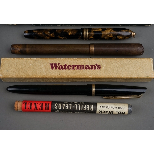 703 - A tin containing a collection of fountain pens, including cased Altura with 14k nib, a brown pen wit... 