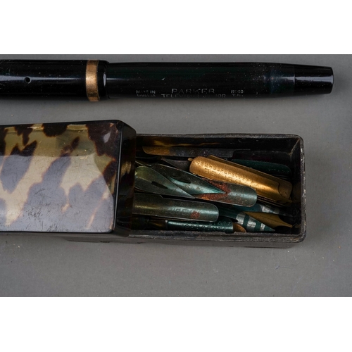 703 - A tin containing a collection of fountain pens, including cased Altura with 14k nib, a brown pen wit... 