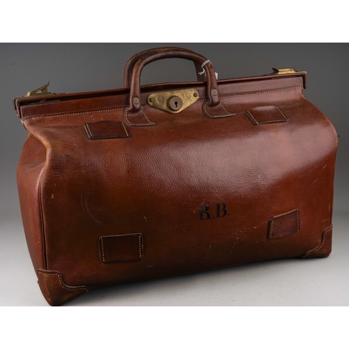 705 - A vintage large brown leather Gladstone bag, the side with initials RB, brass furniture, the body ap... 