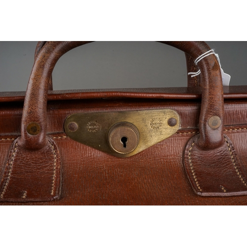 705 - A vintage large brown leather Gladstone bag, the side with initials RB, brass furniture, the body ap... 