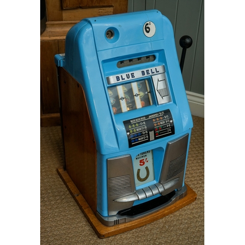 709 - Mill Blue Bell front slot machine ( one arm bandit), with key, working order, takes British 6D coins