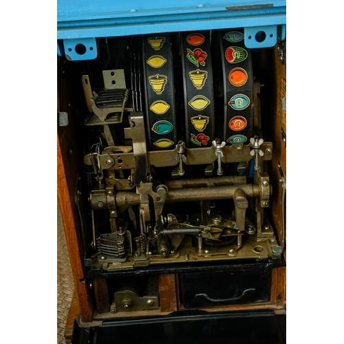 709 - Mill Blue Bell front slot machine ( one arm bandit), with key, working order, takes British 6D coins