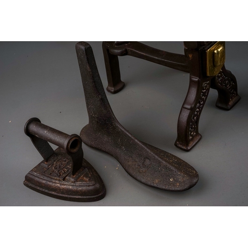 714 - A pair of cast iron fire dogs in manner of Gothic revival together with cobbler's last and small fla... 