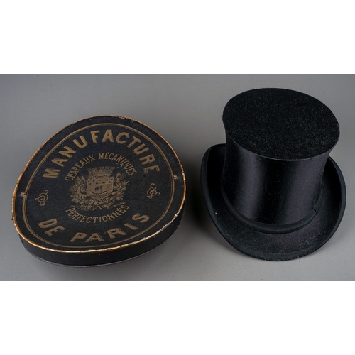 715 - An early 20th century French boxed black silk folding opera hat, the underside of the lid bears labe... 