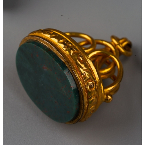 720 - A 19th century gold plated fob, set with bloodstone; a silver swivel fob; two pipe tampers modelled ... 