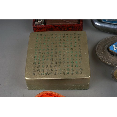 731 - A small tray of collectables, car badges, smoking ephemera, etc, a Chinese bronze ink box with engra... 