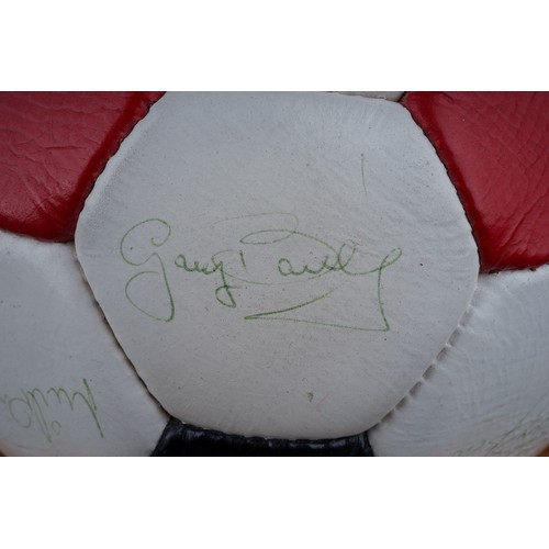 733 - A Manchester United Football Club Official Souvenir Football, bearing faded signatures including Gar... 