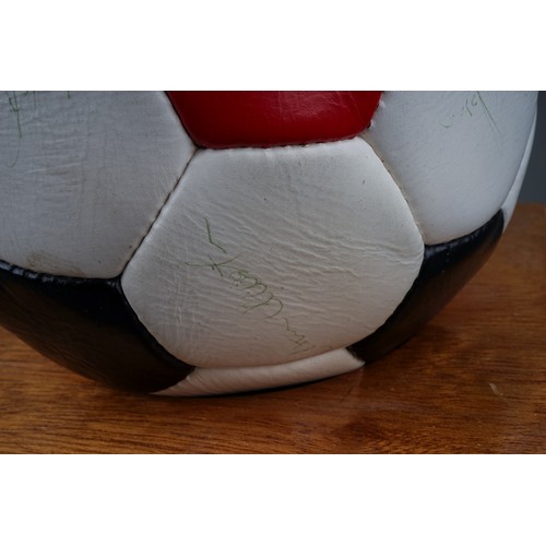 733 - A Manchester United Football Club Official Souvenir Football, bearing faded signatures including Gar... 