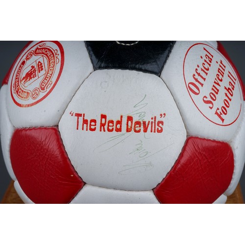 733 - A Manchester United Football Club Official Souvenir Football, bearing faded signatures including Gar... 