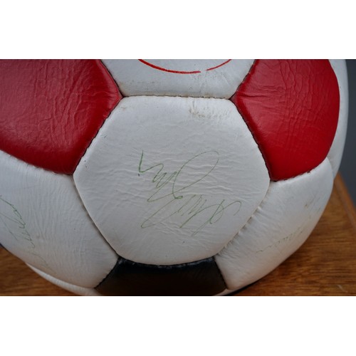 733 - A Manchester United Football Club Official Souvenir Football, bearing faded signatures including Gar... 