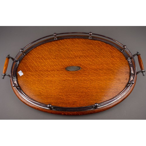 734 - A late 19th century oak and silver plated oval twin handled tray with open gallery, bears oval prese... 