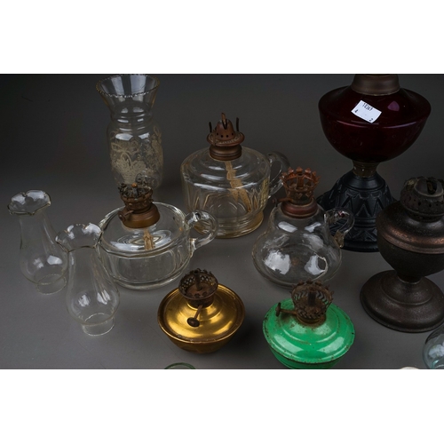 748 - A vintage oil lamp with cast metal stand, ruby glass reservoir together with a group of early 20th C... 