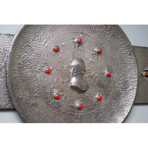 764 - Arts and Crafts Pewter plaque inlaid with 6 enamel plaques and set with 8 red stones to centre. Cent... 