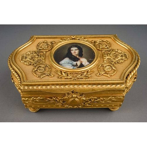 769 - A mid 20th century French gilt metal jewellery box of shaped rectangular form, the hinged cover with... 