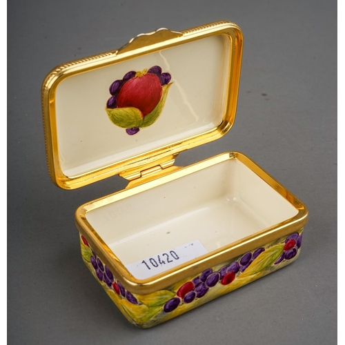 771 - A Moorcroft enamel on copper decorated 'Pomegranate' pattern pill box, hinged lid, printed marks to ... 