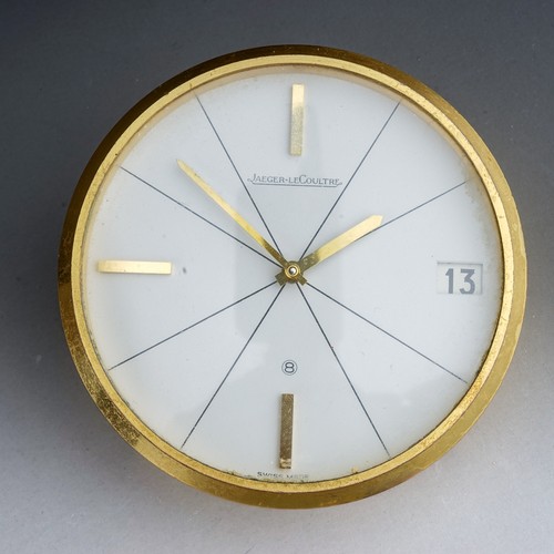 840 - A Jaeger Le Coultre model 383 brushed brass desk clock of circular form, baton markers, date apertur... 