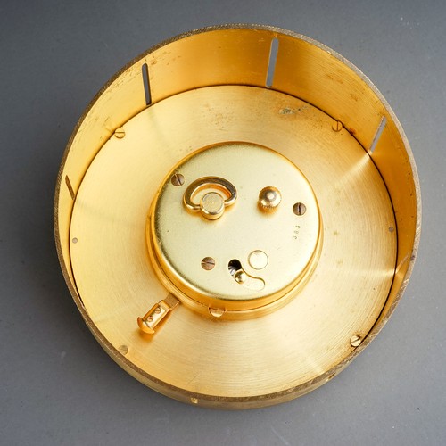 840 - A Jaeger Le Coultre model 383 brushed brass desk clock of circular form, baton markers, date apertur... 