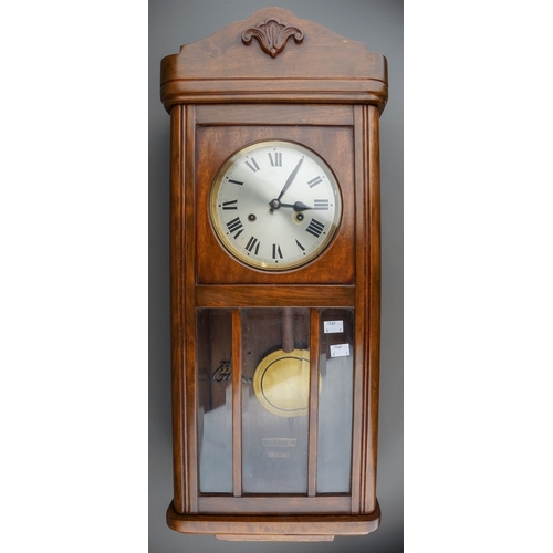 843 - An early 20th Century German mahogany cased H.A.C (Wurttemberg) wall clock with pendulum, glazed sin... 