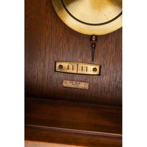 843 - An early 20th Century German mahogany cased H.A.C (Wurttemberg) wall clock with pendulum, glazed sin... 