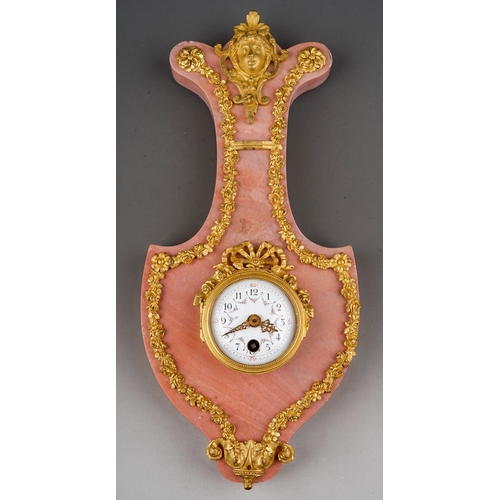 844 - A late 19th century French rose marble and gilt metal cartel clock, applied mask to the shaped top, ... 