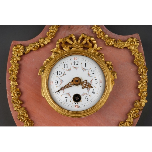 844 - A late 19th century French rose marble and gilt metal cartel clock, applied mask to the shaped top, ... 