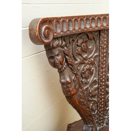 852 - A late 19th / early 20th century carved oak Italian Sgabello hall chair, profusely carved with carya... 