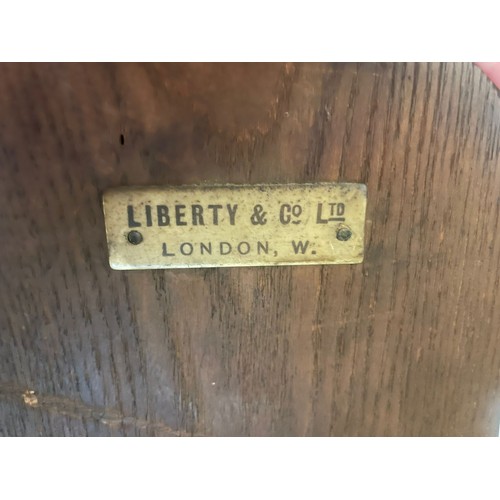 862 - A Liberty and Co Arts and Crafts oak open bookcase baring the original label to back. Measuring appr... 