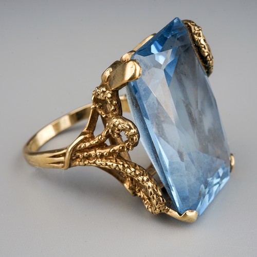 119 - A 9ct yellow gold and synthetic spinel dress ring, the large blue stone approx 25mm x 17mm x 9.9mm, ... 