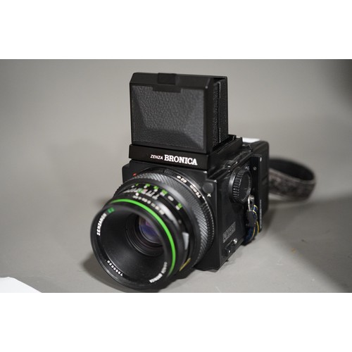 664 - A zenza Bronica ETRS medium format camera with a zenzanon 75mm f/2.8 lens along with two film back m... 