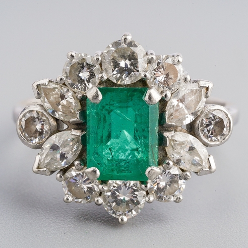 15 - A platinum emerald and diamond cluster ring, set with an emerald-cut emerald approx 7.00mm x 5.35mm ... 