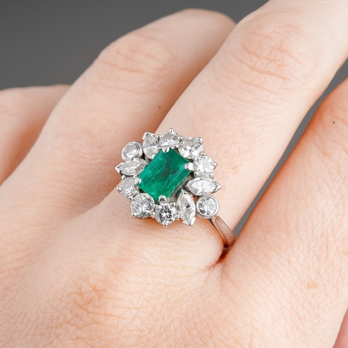 15 - A platinum emerald and diamond cluster ring, set with an emerald-cut emerald approx 7.00mm x 5.35mm ... 