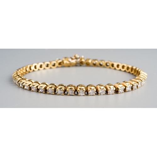 17 - An 18ct yellow gold and diamond line bracelet, set with forty-six round brilliant-cut diamonds, esti... 