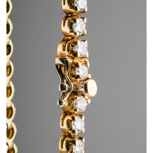 17 - An 18ct yellow gold and diamond line bracelet, set with forty-six round brilliant-cut diamonds, esti... 