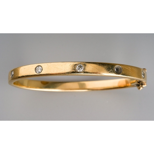 18 - A yellow gold and diamond hinged bangle set with four round brilliant-cut diamonds (one missing), es... 