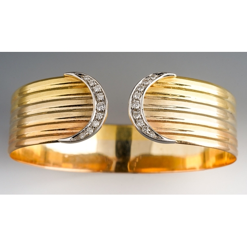 19 - An 18ct tri-colour gold and diamond torque bangle, grooved decoration with crescent terminals, each ... 