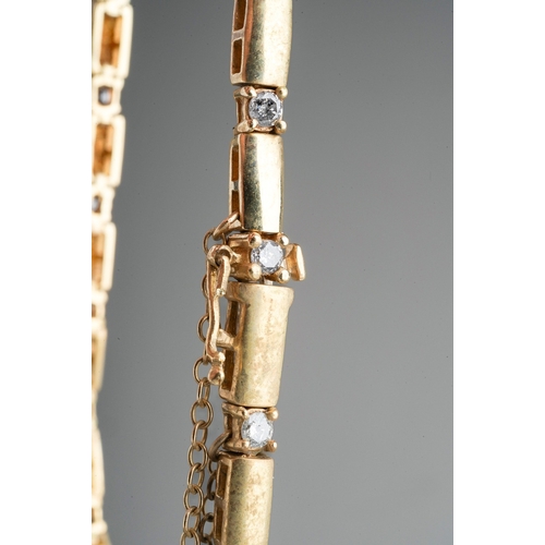 22 - A 9ct yellow gold and diamond bracelet, set with nineteen round brilliant-cut diamonds, estimated to... 