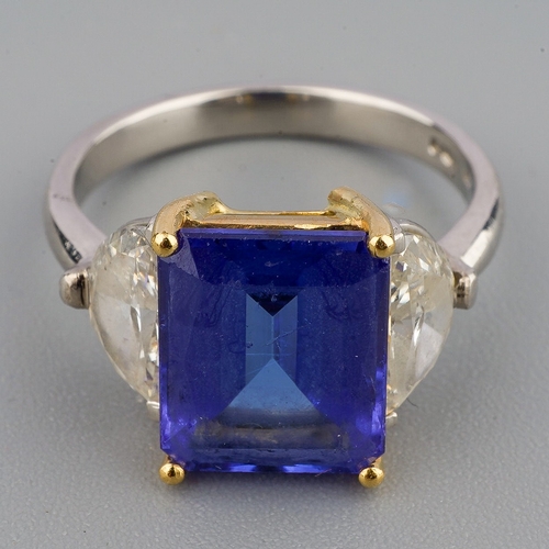 40 - A tanzanite and diamond three stone ring, set with a principal tanzanite and two half moon cut diamo... 