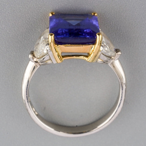 40 - A tanzanite and diamond three stone ring, set with a principal tanzanite and two half moon cut diamo... 