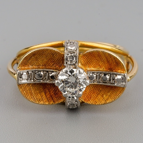 46 - A mid 20th century diamond dress ring, set with a round brilliant cut diamond, claw set to the textu... 