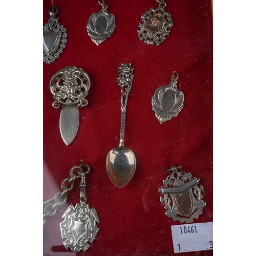 59 - A boxed silver and CZ line tennis bracelet; a silver charm bracelet and a framed collection of silve... 